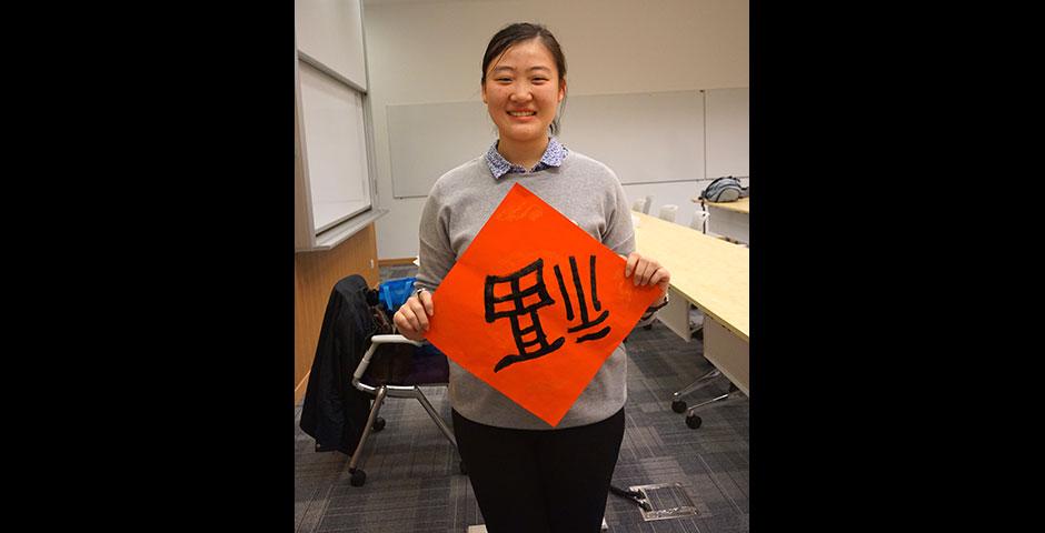 Students prepare for the Year of the Sheep with Chinese New Year writings. February 13, 2015. (Photo by Mei Wu)