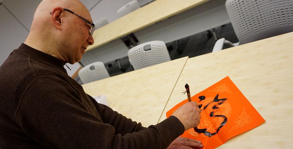 Students prepare for the Year of the Sheep with Chinese New Year writings. February 13, 2015. (Photo by Mei Wu)