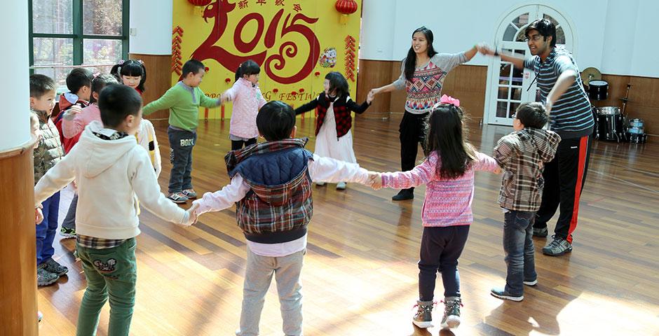 NYU Shanghai's Xiao Long Shakers hold a weekly volunteer dance workshop at Songlin Kindergarten, where students will perform their routines at the end of the semester. March 24, 2015. (Photo by Kevin Pham)