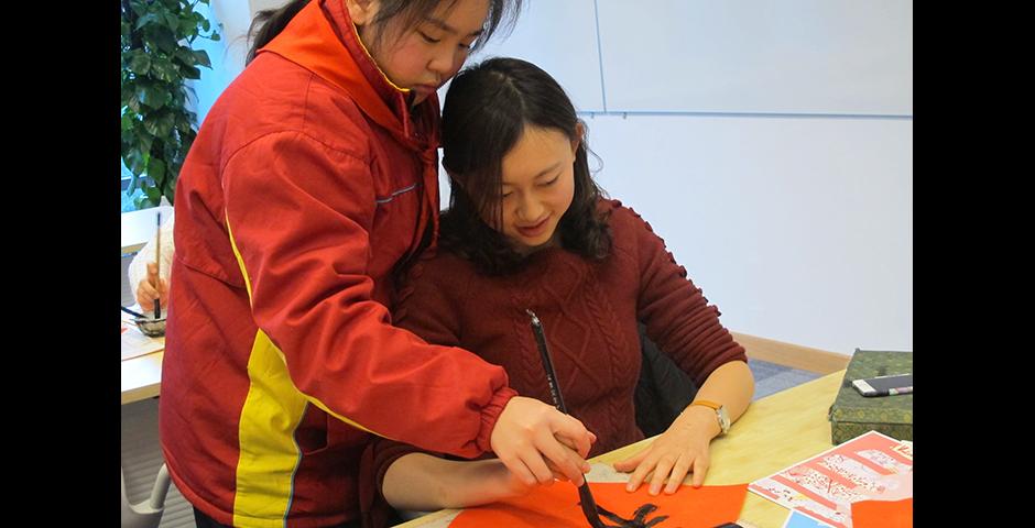 Student activities marking the celebration of Chinese New Year included paper-cutting craft workshops, games and scroll painting. (Photo by: NYU Shanghai)