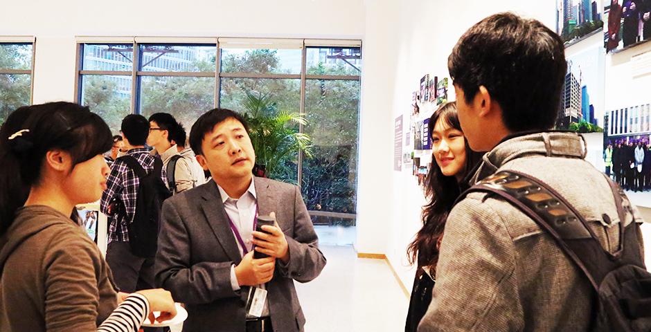 Students discuss their business studies with the Vice Dean of Business, Yuxin Chen, October 16, 2014. (Photo by Annie Seaman)