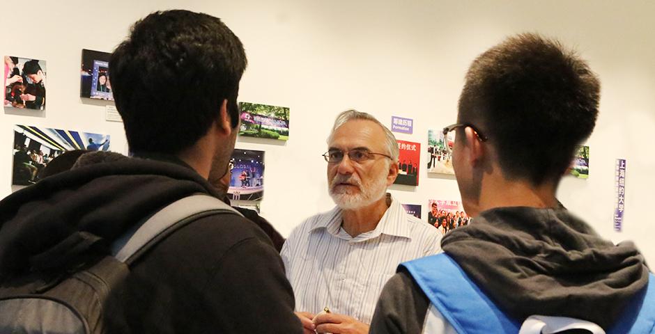 Students discuss their business studies with the Dean of Business, Eitan Zemel, October 16, 2014. (Photo by Annie Seaman)