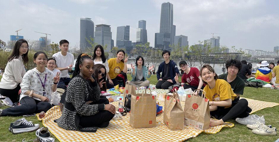 [Beyond the Magnolia House] April 15 2023, a beautiful sunny spring day, a group of 10 first-year students joined the Biking &amp; Picnic event. The biking group biked through World Expo Park along the Huangpu River and met up with the picnic group at Qiantan Leisure Park Camping Zone (near Youcheng Park Gate 6). Students then enjoyed snacks, beverages, and McDonald’s as well as playing fun board games and frisbees on the grass.