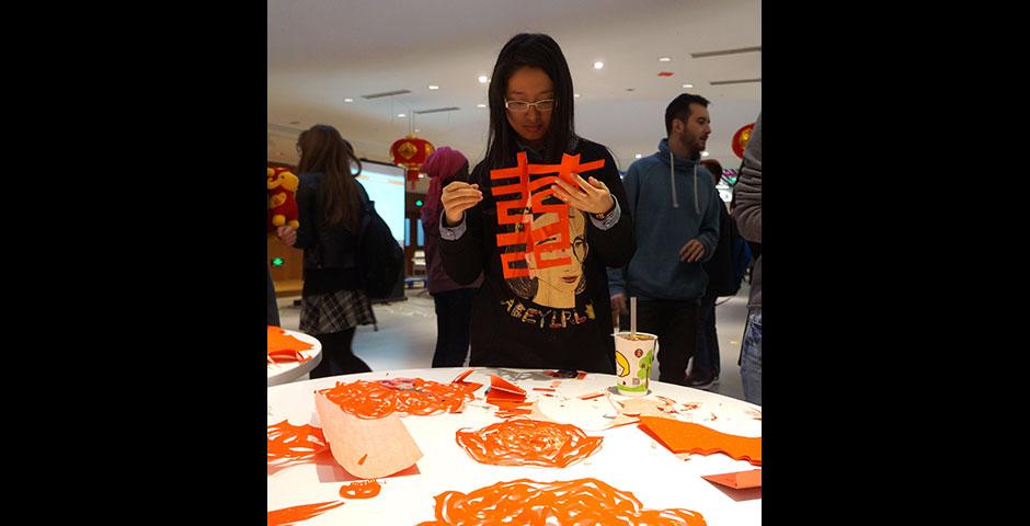 In honor of China's annual Lantern Festival, which marks the last day of Lunar New Year celebrations, students participate in paper cutting, learn Chinese calligraphy, and cook traditional tangyuan (汤圆). March 5, 2015. (Photo by Charlotte San Juan)