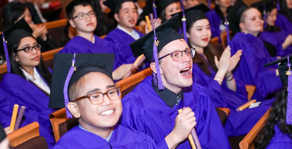 Tyler Roman and John Rhoades cheer on their classmates