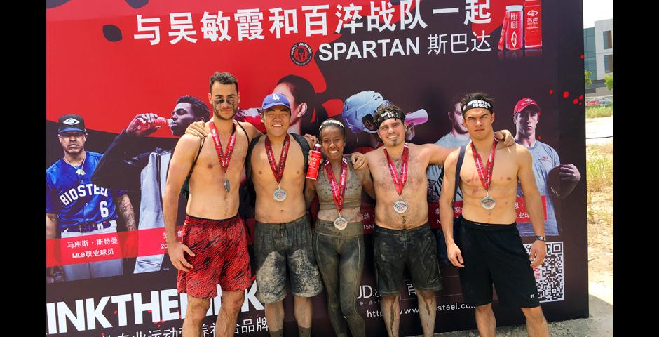 On Sunday May 21st, five NYU Shanghai students competed in the Shanghai Spartan Sprint. The race consisted of a 6.7 kilometer course with 23 obstacles ranging from rope climbs to barbed wire crawls. The journey was difficult, but these students were proud to represent NYU Shanghai. During their time as NYU Shanghai students, these five have faced many obstacles. However just like during the race on Sunday, unity and teamwork propelled everyone through the finish line. The students are as follows from left to right: Louis Demetroulakos 19', Jimmy Kim 17', Olivia Taylor 17', Jarred Kubas 17', and Alex Mayes 17'.