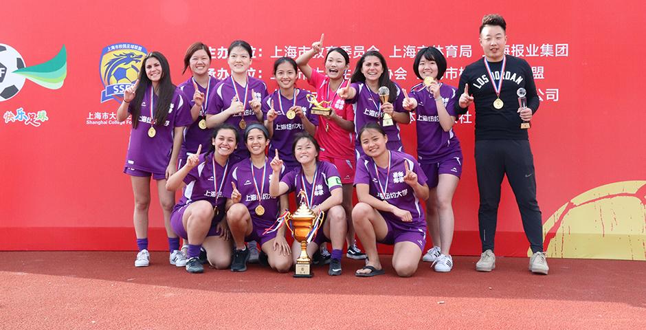 From left to right, the members of the Shanghai Women's Soccer team are Sabrina Bitar, Kai Zheng, Eliza Cohen, Xixi Lai, Winny Wang, Sarah Bitar, Xinyu Li (Back row), and Anique Toscano, Sydney Fontalvo, Amy Decills, Kate Thoma-Hilliard (Front row). They are coached by Darren Lu. Not pictured: Nathalia Lin, Sybil Snow, Alice Zeng.