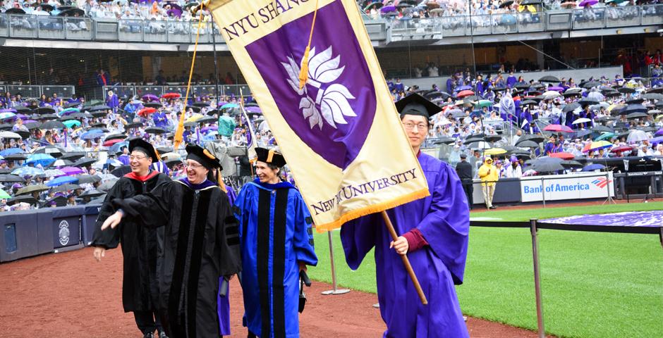 NYU Shanghai graduate Su Han&#039;18 carried the banner for the university, alongside representatives from all of NYU&#039;s schools and campuses ( Photo by: Leo Sorel )