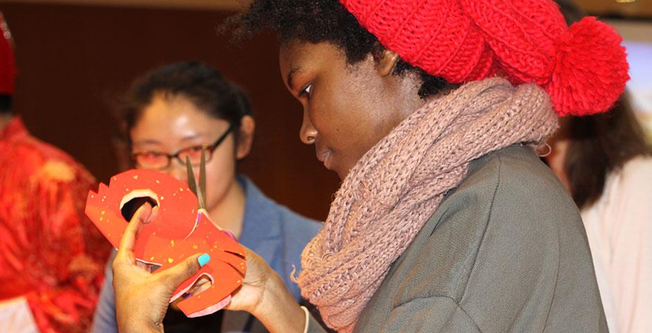 In honor of China's annual Lantern Festival, which marks the last day of Lunar New Year celebrations, students participate in paper cutting, learn Chinese calligraphy, and cook traditional tangyuan (汤圆). March 5, 2015. (Photo by Liming Shi)