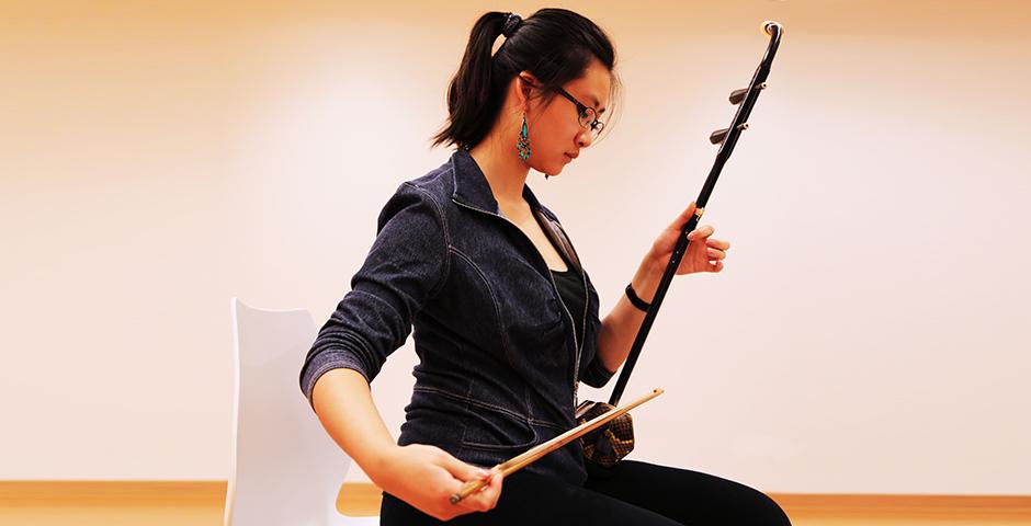 Students practice playing the traditional Chinese instrument, the Er Hu, October 20, 2014. (Photo by Annie Seaman)