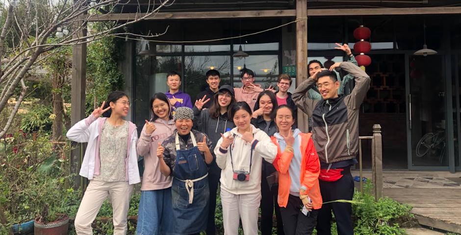 Students pose with the hostel landlady who cooked fish-fragrant eggplant.  “There is so much that can be learned from outside the classrooms, which when we do come back provides so much for us to reflect on and integrate into academic studies,” said Community Engaged Learning Coordinator Qian Chunhao.