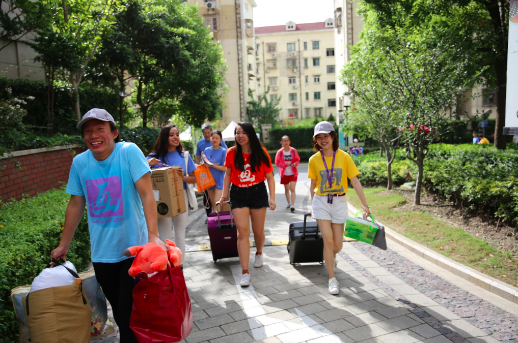 Hands are full and spirits are high as upperclass Orientation Ambassadors help new students with their luggage.