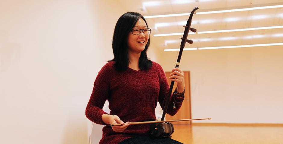 Students practice playing the traditional Chinese instrument, the Er Hu, October 20, 2014. (Photo by Annie Seaman)