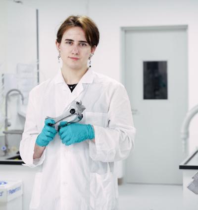 Carter in a labcoat standing in the chemistry lab