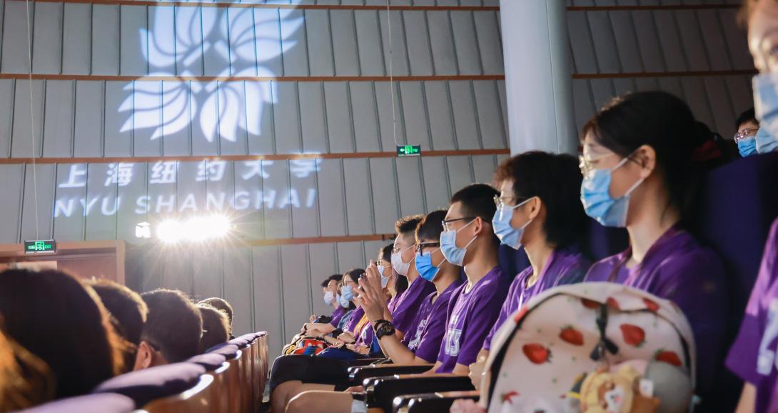 NYU Shanghai spotlight illuminates room filled with students