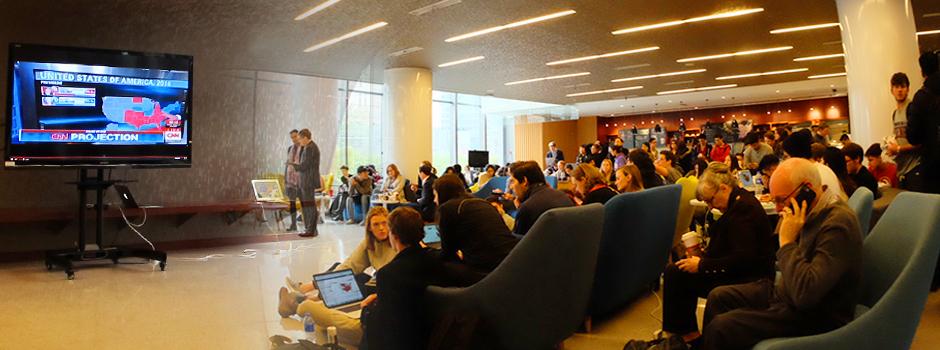 A group of people watching the wall screen