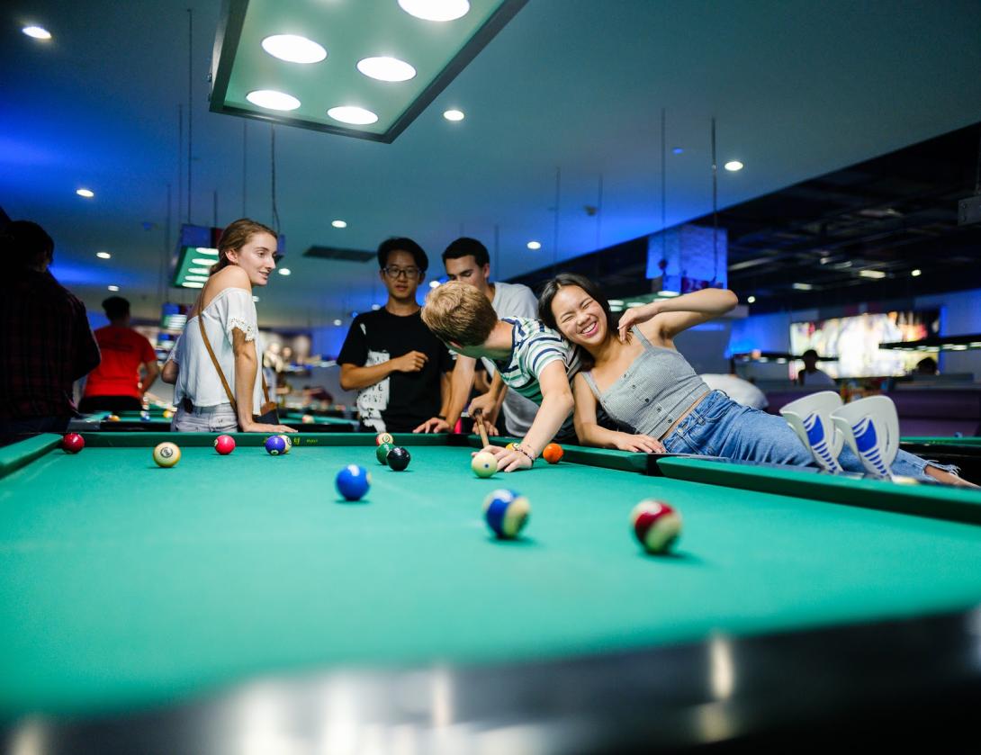 Class of 2022 students playing pool